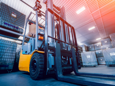 Electric forklift in a warehouse