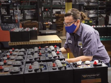 Crown Battery Employee working in plant