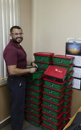 Employee Organizes Operation Christmas Child Boxes