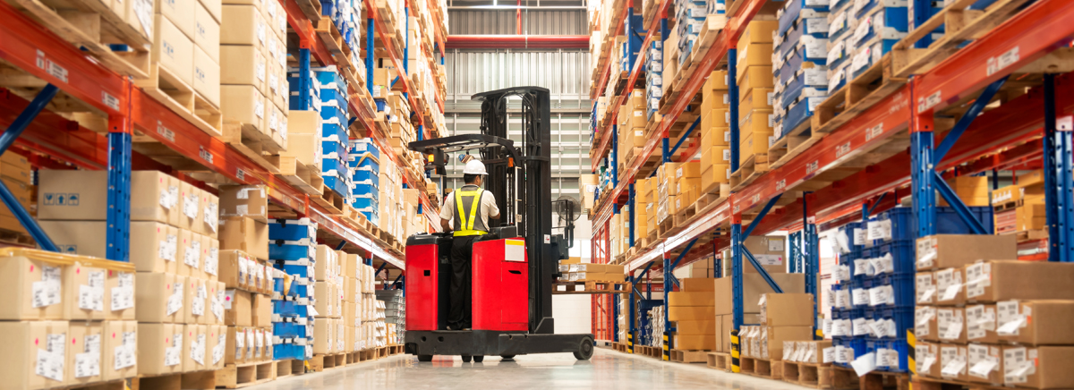 A forklift moves product in a warehouse. A forklift moves product in a warehouse.