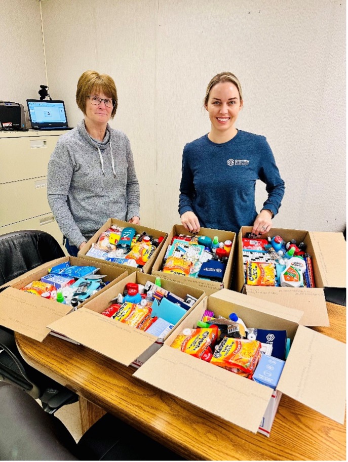 Stryten Employees prepare boxes for military personnel