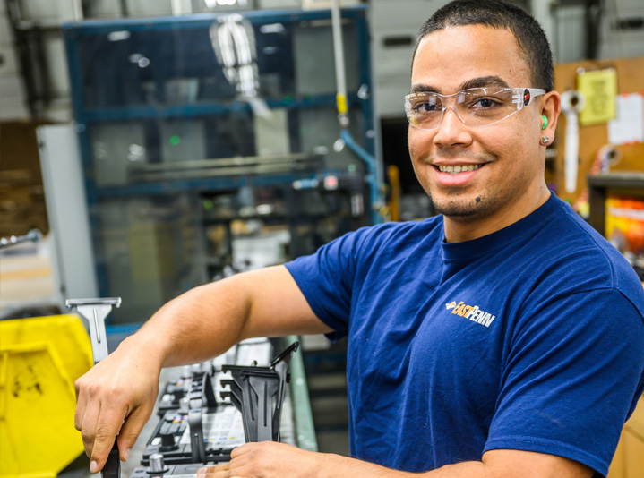 East Penn employee applying battery labels