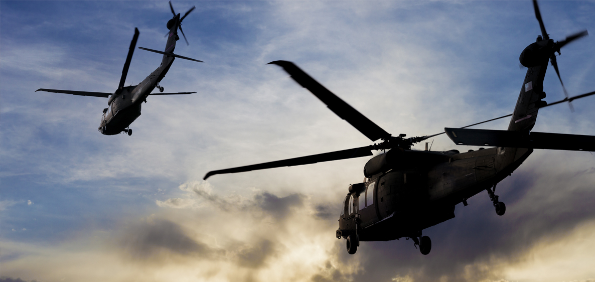 Military helicopters flying in the air for U.S. national defense.