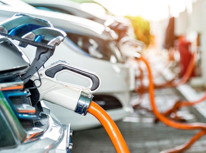 Electric vehicles charging at an EV charging station.