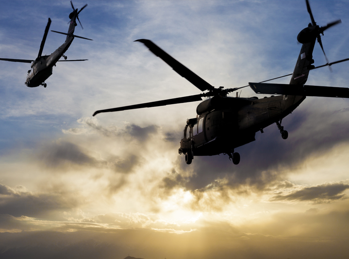 Military helicopters flying in the air on a military tactical operation.