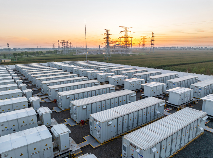 Large bank of batteries for microgrid storage with powerlines in the background.