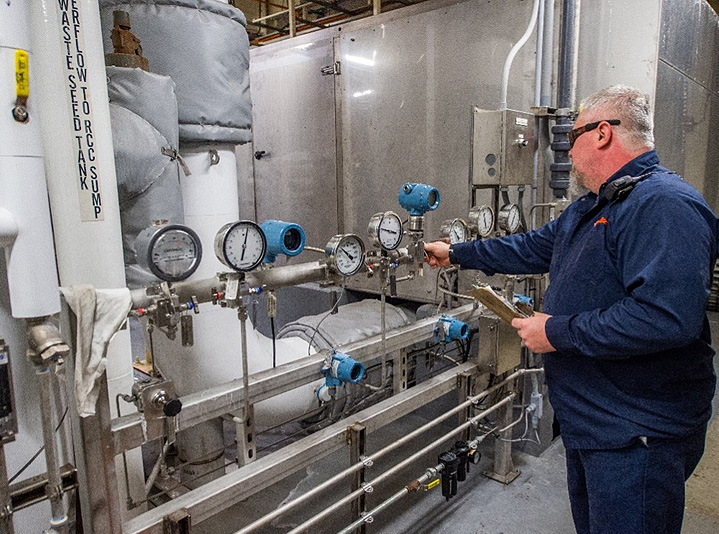 Technician working inside an East Penn battery recycling facility.