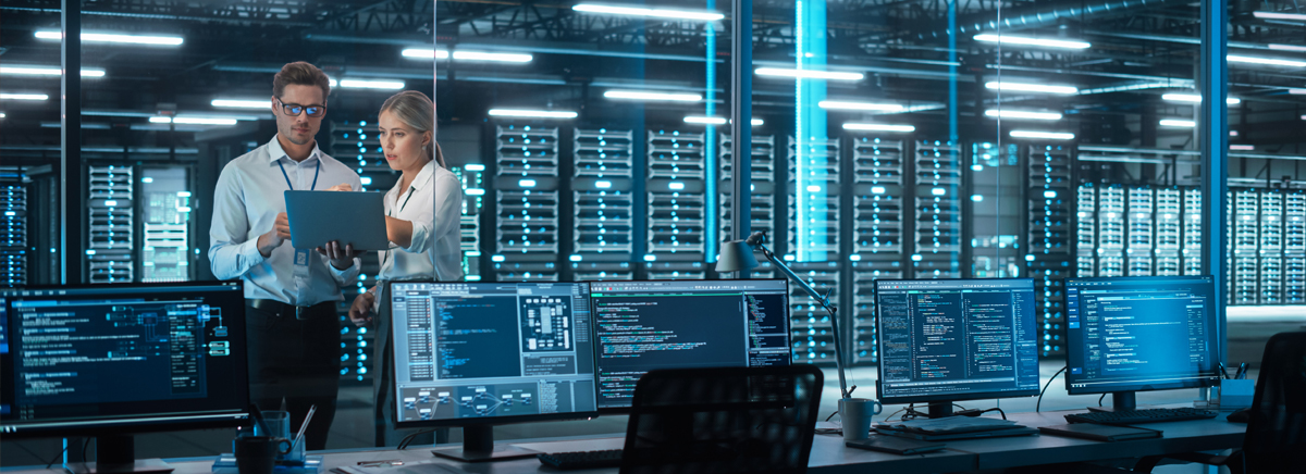 Two people working in a data center.