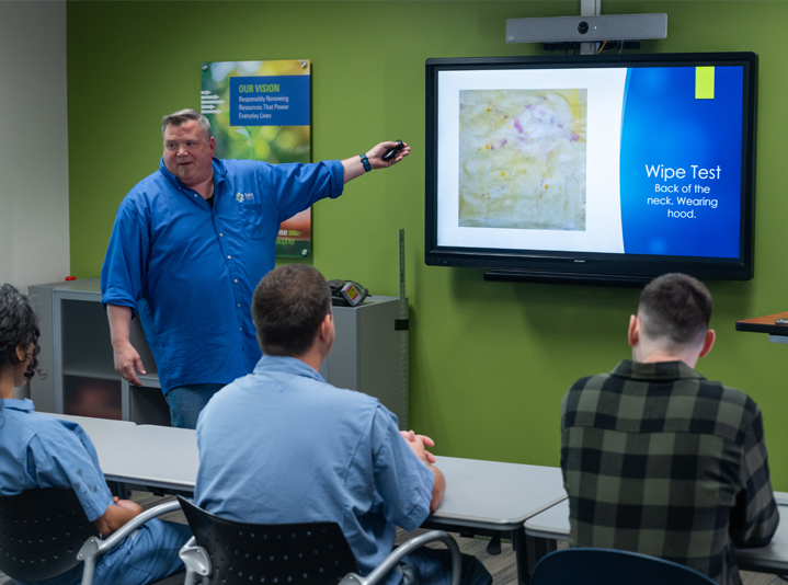 Employee health and safety training class at a lead battery recycling facility.