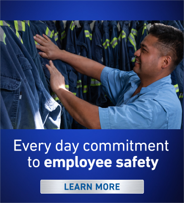 Lead battery industry employee getting coveralls for employee safety.