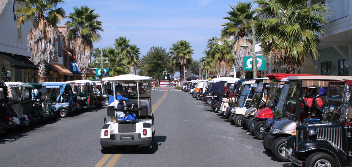 golf carts parked on a busy shopping street